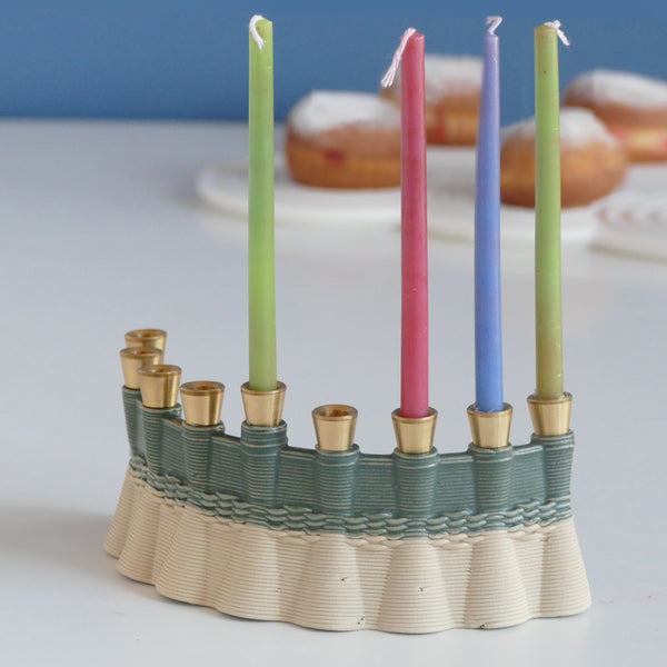 This innovative Hanukkah Menorah has an arc shape with weaving pattern - created in a unique method by a clay 3D Printer. Its gentle details and modest proportions - make it look like a jewel.