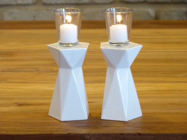 A Pair of Shabbat candlesticks designed in geometric style. These two sided candle holders fits tall celebrative Shabbat candles on one side