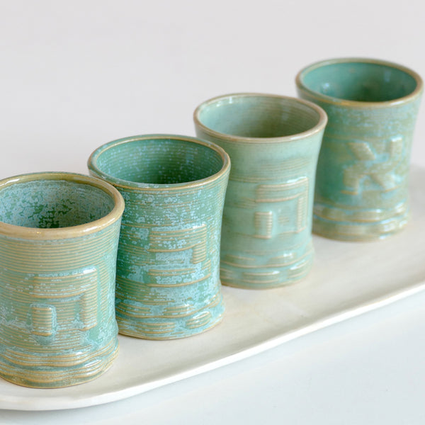 A unique gift for Shabbat table - a set of One Kiddush cup with customized small wine goblets - each cup is printed with an Hebrew letter embossed over its surface.