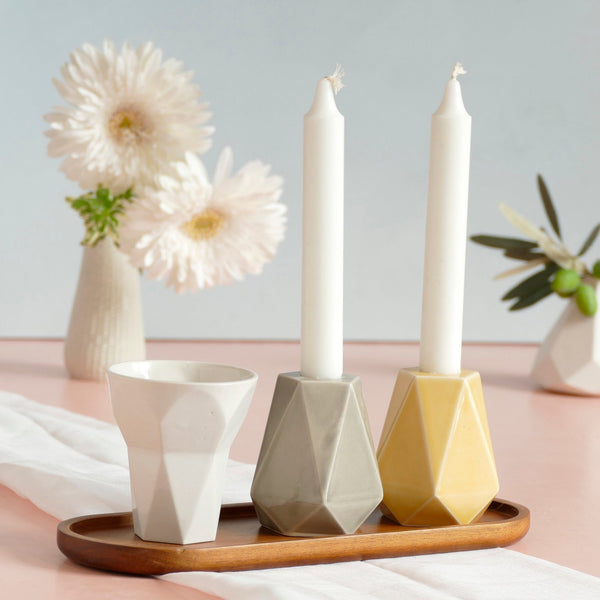 Mystery box of Shabbat table set, includes a Hexagon shaped Kiddush cup and pair of pentagon candlesticks, with matching bamboo tray.
The items that make up each set are fixed - the glazes combination varies from a range of pastel colors, off-white and gray.
Pictures show different combinations of glazes - the exact colors combination of your set is a surprise.