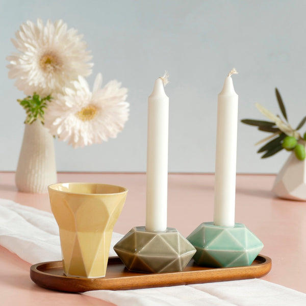 Mystery box of Shabbat table set, includes a Hexagon shaped Kiddush cup and pair of hexagon candlesticks, with matching bamboo tray.
The items that make up each set are fixed - the glazes combination varies from a range of pastel colors, off-white and gray.
Pictures show different combinations of glazes - the exact colors combination of your set is a surprise.