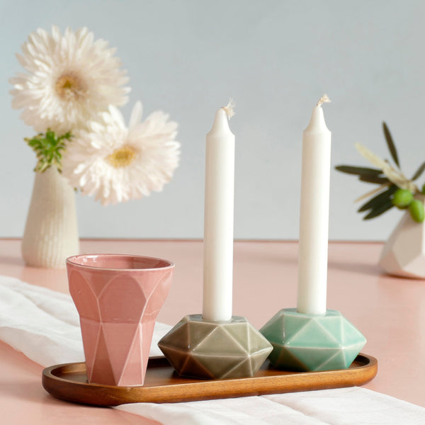 Mystery box of Shabbat table set, includes a Hexagon shaped Kiddush cup and pair of hexagon candlesticks, with matching bamboo tray.
The items that make up each set are fixed - the glazes combination varies from a range of pastel colors, off-white and gray.
Pictures show different combinations of glazes - the exact colors combination of your set is a surprise.