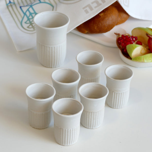 This elegant Kiddush cups set has pearls pattern - created in a unique method by a clay 3D Printer. The set includes one large Kiddish wine goblet and six matching small cups.