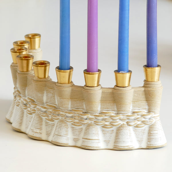 This innovative Hanukkah Menorah has an arc shape with weaving pattern - created in a unique method by a clay 3D Printer. The Shamash placed at the edge of the arc, you may choose setting the Menorah concave or convex - with the Shamash on the right or on the left.
