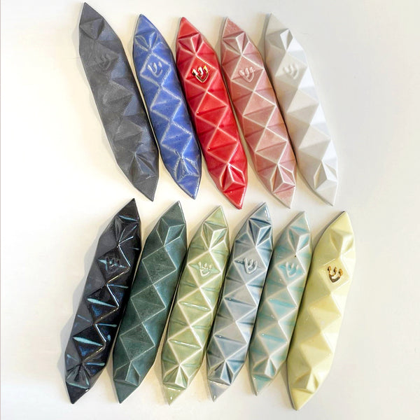 Mystery box of 3 Mezuzah cases, hand made of ceramic - inspired by Origami.
The box includes three Mezuzah cases in the same design - the glazes combination is a surprise - three different colors - in attractive discount of 50%.