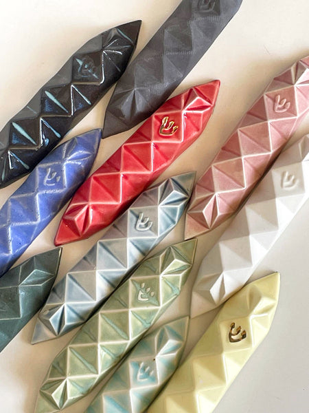 Mystery box of 3 Mezuzah cases, hand made of ceramic - inspired by Origami.
The box includes three Mezuzah cases in the same design - the glazes combination is a surprise - three different colors - in attractive discount of 50%.