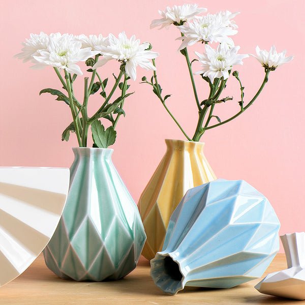 geometric vases in pastel colors with white flowers