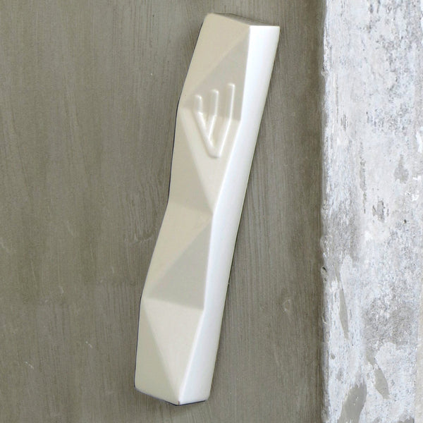 A modern Mezuzah case in contemporary geometric Judaica style, an original Israeli design gift for wedding, or trendy housewarming Jewish gift.
Made of white ceramic