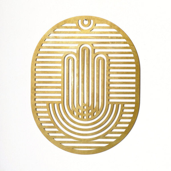 brass hamsa inspired by op art