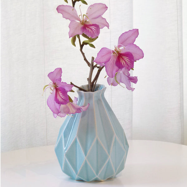 Light blue ceramic vase in geometric origami style