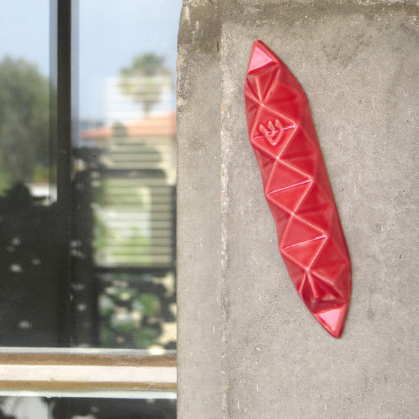 A modern Mezuzah case inspired by Origami, a piece of contemporary geometric Judaica. This Mezuzah case will fit your front door, and will make a stylish statement entrance to your home.