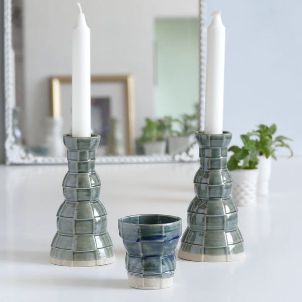 An innovative Shabbat table set, with Pair of candlesticks and Kiddush cup. Designed in geometric modern Judaica style, manufactured in our studio in a unique method of clay 3D printing.
With its geometric checkered grid pattern - these Kiddish set brings the newest design trend to your Shabbat evening table.