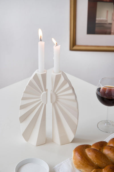 Outlet item - last pieces from previous collection - now on 50% discount.  A Pair of candlesticks designed in geometric style, a pair of white ceramic candlesticks