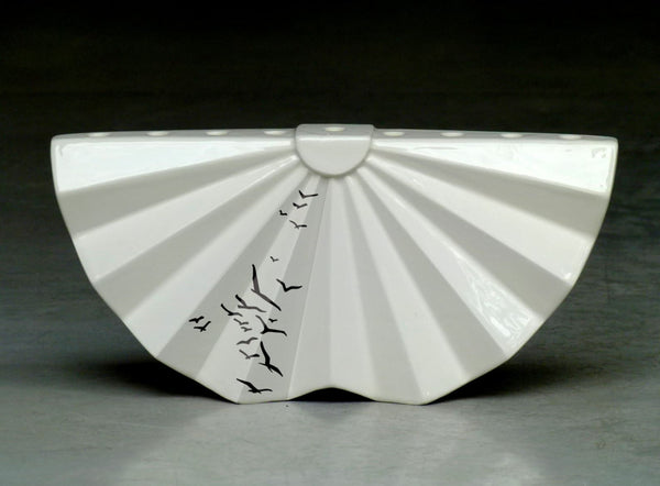 A Hanukkah Menorah in Modern geometric Judaica design, made of white ceramic with birds pattern . A contemporary Judaica Chanukah & wedding gift