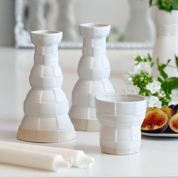 An innovative Shabbat table set, with Pair of candlesticks and Kiddush cup. Designed in geometric modern Judaica style, manufactured in our studio in a unique method of clay 3D printing.