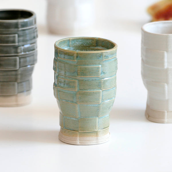 An innovative Shabbat table set, with Pair of candlesticks and Kiddush cup. Designed in geometric modern Judaica style, manufactured in our studio in a unique method of clay 3D printing.