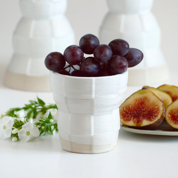 With its geometric checkered pattern - these Kiddish set brings the newest design trend to your Shabbat evening table. Inspired by 60's and 80's pop style - These beige and off- white shade ceramic candle holders and wine cup are a beautiful contemporary Jewish gift