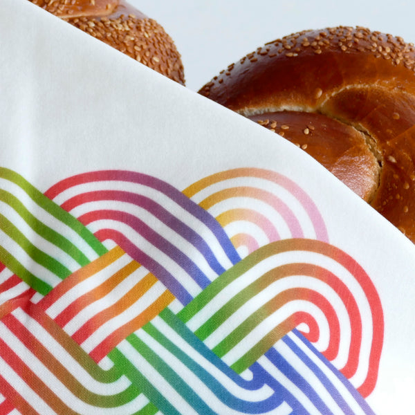 the graphic Challah print of this cover matches perfectly the more minimalistic Challah design engraved on our Corian Challah board - Together they make a perfect Shabbat Set