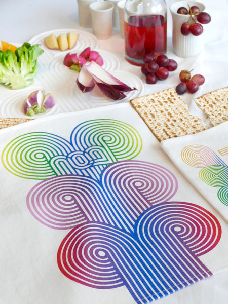 stylish and trendy set of a Matzah cover and Afikoman bag, crafted from fine off-white cotton. The design features an op-art-inspired wave pattern in stunning multicolor Ombre tones, printed using state-of-the-art 'Kornit Digital' textile printers. This design draws inspiration from the story of Exodus, merging tradition with contemporary aesthetic.