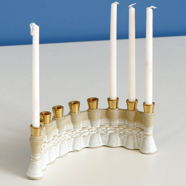 This innovative Hanukkah Menorah has an arc shape with weaving pattern - created in a unique method by a clay 3D Printer. Its gentle details and modest proportions - make it look like a jewel.