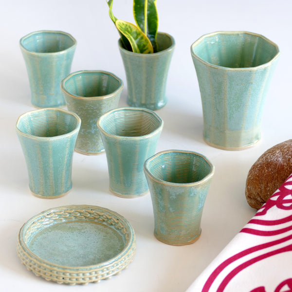 The set includes one large Kiddish wine goblet and six matching small cups.