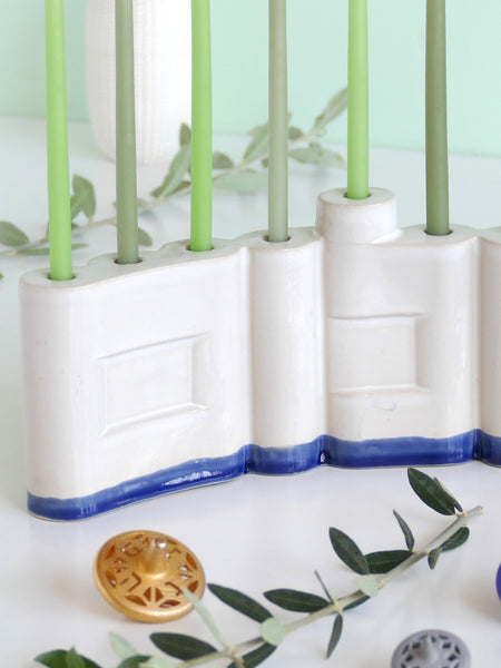 We designed the letters of "Shalom" in a minimalist, geometric style to form the Menorah's nine branches, with the central 'Lamed' (ל) serving as the Shamash.

Thanks to the completeness of the word שלום, it can be read clearly and elegantly from both sides of the Menorah – the convex and the concave. This dual-sided design makes it perfect as a table centerpiece or to place on a windowsill, projecting the message of peace both inwards and outwards.