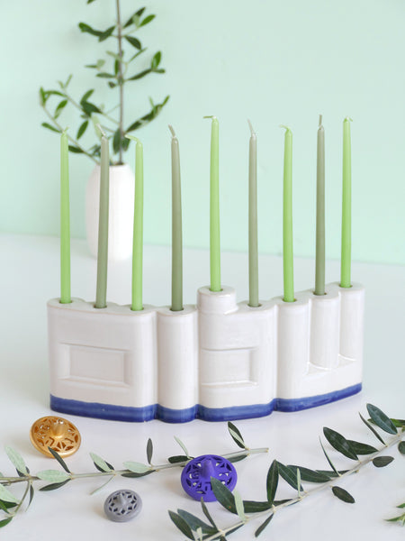 We designed the letters of "Shalom" in a minimalist, geometric style to form the Menorah's nine branches, with the central 'Lamed' (ל) serving as the Shamash.

Thanks to the completeness of the word שלום, it can be read clearly and elegantly from both sides of the Menorah – the convex and the concave. This dual-sided design makes it perfect as a table centerpiece or to place on a windowsill, projecting the message of peace both inwards and outwards.