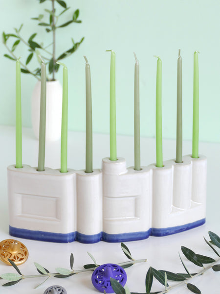 We designed the letters of "Shalom" in a minimalist, geometric style to form the Menorah's nine branches, with the central 'Lamed' (ל) serving as the Shamash.

Thanks to the completeness of the word שלום, it can be read clearly and elegantly from both sides of the Menorah – the convex and the concave. This dual-sided design makes it perfect as a table centerpiece or to place on a windowsill, projecting the message of peace both inwards and outwards.