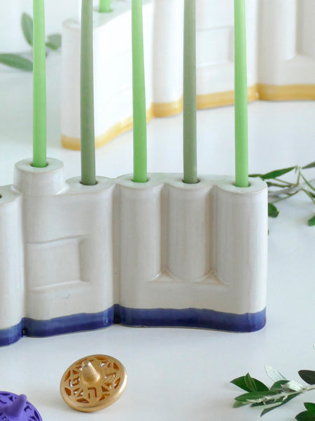 We designed the letters of "Shalom" in a minimalist, geometric style to form the Menorah's nine branches, with the central 'Lamed' (ל) serving as the Shamash.

Thanks to the completeness of the word שלום, it can be read clearly and elegantly from both sides of the Menorah – the convex and the concave. This dual-sided design makes it perfect as a table centerpiece or to place on a windowsill, projecting the message of peace both inwards and outwards.