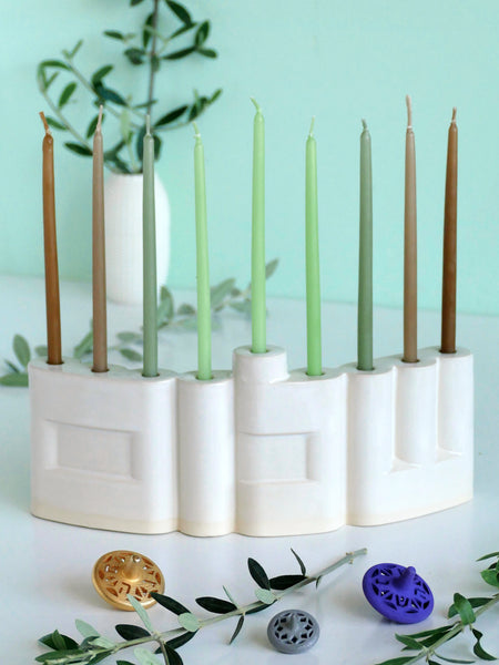 Hanukkah Menorah designed with the letters of "Shalom" שלום in a minimalist, geometric style to form the Menorah's nine branches, with the central 'Lamed' (ל) serving as the Shamash.

 it can be read clearly and elegantly from both sides of the Menorah – the convex and the concave. This dual-sided design makes it perfect as a table centerpiece or to place on a windowsill, projecting the message of peace both inwards and outwards.
