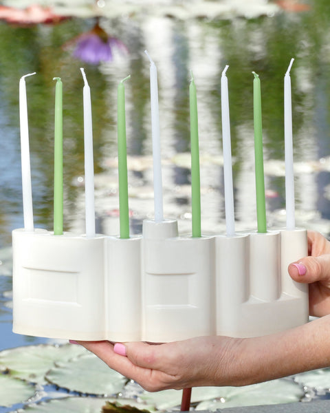 Hanukkah Menorah designed with the letters of "Shalom" שלום in a minimalist, geometric style to form the Menorah's nine branches, with the central 'Lamed' (ל) serving as the Shamash.

 it can be read clearly and elegantly from both sides of the Menorah – the convex and the concave. This dual-sided design makes it perfect as a table centerpiece or to place on a windowsill, projecting the message of peace both inwards and outwards.
