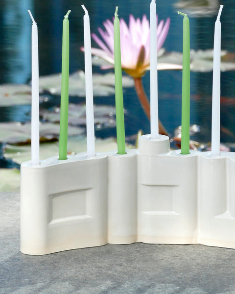 Hanukkah Menorah designed with the letters of "Shalom" שלום in a minimalist, geometric style to form the Menorah's nine branches, with the central 'Lamed' (ל) serving as the Shamash.

 it can be read clearly and elegantly from both sides of the Menorah – the convex and the concave. This dual-sided design makes it perfect as a table centerpiece or to place on a windowsill, projecting the message of peace both inwards and outwards.
