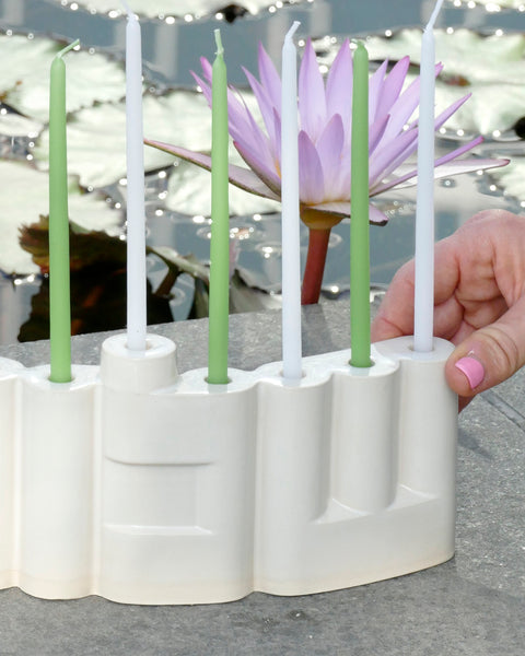 Hanukkah Menorah designed with the letters of "Shalom" שלום in a minimalist, geometric style to form the Menorah's nine branches, with the central 'Lamed' (ל) serving as the Shamash.

 it can be read clearly and elegantly from both sides of the Menorah – the convex and the concave. This dual-sided design makes it perfect as a table centerpiece or to place on a windowsill, projecting the message of peace both inwards and outwards.
