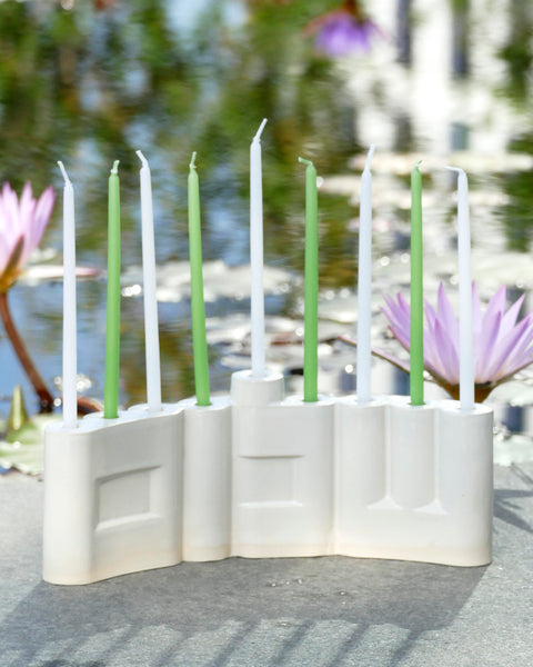 Hanukkah Menorah designed with the letters of "Shalom" שלום in a minimalist, geometric style to form the Menorah's nine branches, with the central 'Lamed' (ל) serving as the Shamash.

 it can be read clearly and elegantly from both sides of the Menorah – the convex and the concave. This dual-sided design makes it perfect as a table centerpiece or to place on a windowsill, projecting the message of peace both inwards and outwards.
