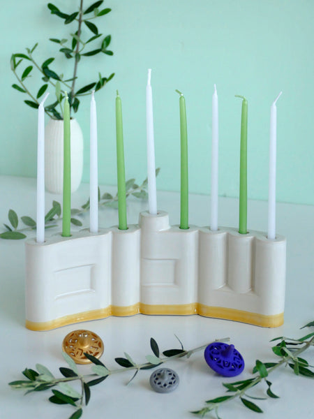 Hanukkah Menorah designed with the letters of "Shalom" שלום in a minimalist, geometric style to form the Menorah's nine branches, with the central 'Lamed' (ל) serving as the Shamash.

 it can be read clearly and elegantly from both sides of the Menorah – the convex and the concave. This dual-sided design makes it perfect as a table centerpiece or to place on a windowsill, projecting the message of peace both inwards and outwards.
