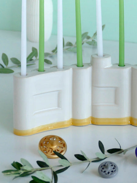 Hanukkah Menorah designed with the letters of "Shalom" שלום in a minimalist, geometric style to form the Menorah's nine branches, with the central 'Lamed' (ל) serving as the Shamash.

 it can be read clearly and elegantly from both sides of the Menorah – the convex and the concave. This dual-sided design makes it perfect as a table centerpiece or to place on a windowsill, projecting the message of peace both inwards and outwards.
