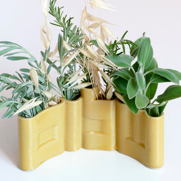 Innovative “Shalom” Vase

This unique vase features the Hebrew word Shalom (שלום) in an elegant arc form, crafted with cutting-edge clay 3D printing technology. Finished with a glossy yellow glaze, it functions beautifully as a modern flower or greenery pot.

