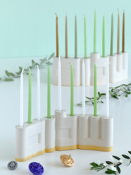 Hanukkah Menorah designed with the letters of "Shalom" שלום in a minimalist, geometric style to form the Menorah's nine branches, with the central 'Lamed' (ל) serving as the Shamash.

Thanks to the completeness of the word שלום, it can be read clearly and elegantly from both sides of the Menorah – the convex and the concave. This dual-sided design makes it perfect as a table centerpiece or to place on a windowsill, projecting the message of peace both inwards and outwards.
