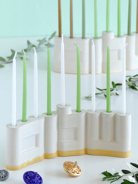 Hanukkah Menorah designed with the letters of "Shalom" שלום in a minimalist, geometric style to form the Menorah's nine branches, with the central 'Lamed' (ל) serving as the Shamash.

Thanks to the completeness of the word שלום, it can be read clearly and elegantly from both sides of the Menorah – the convex and the concave. This dual-sided design makes it perfect as a table centerpiece or to place on a windowsill, projecting the message of peace both inwards and outwards.
