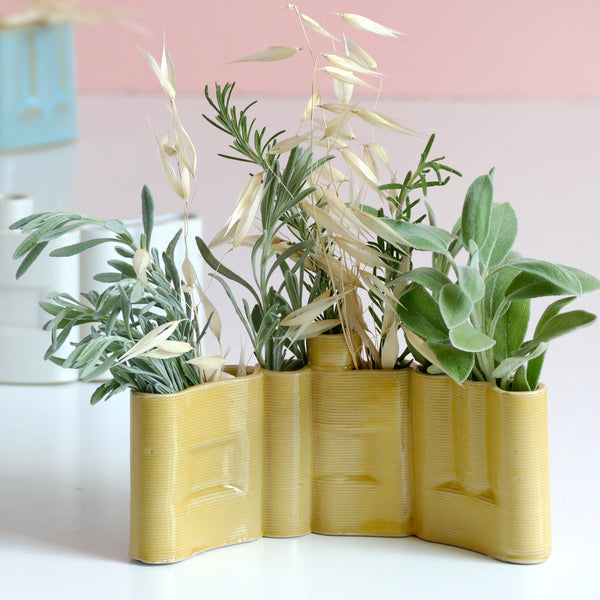 Innovative “Shalom” Vase

This unique vase features the Hebrew word Shalom (שלום) in an elegant arc form, crafted with cutting-edge clay 3D printing technology. Finished with a glossy yellow glaze, it functions beautifully as a modern flower or greenery pot.

