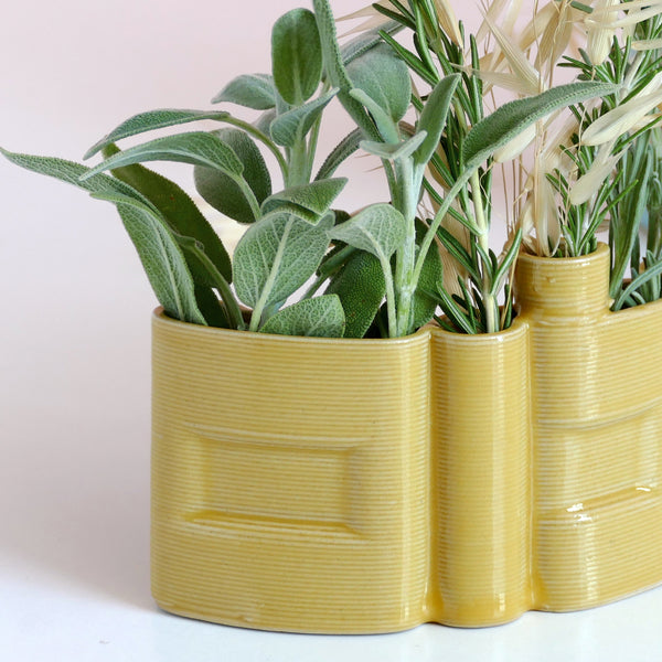 Innovative “Shalom” Vase

This unique vase features the Hebrew word Shalom (שלום) in an elegant arc form, crafted with cutting-edge clay 3D printing technology. Finished with a glossy yellow glaze, it functions beautifully as a modern flower or greenery pot.

We invite Judaica and Israeli design lovers to join our journey and enjoy 25% off on one of the very first 3D-printed clay Shalom vases.