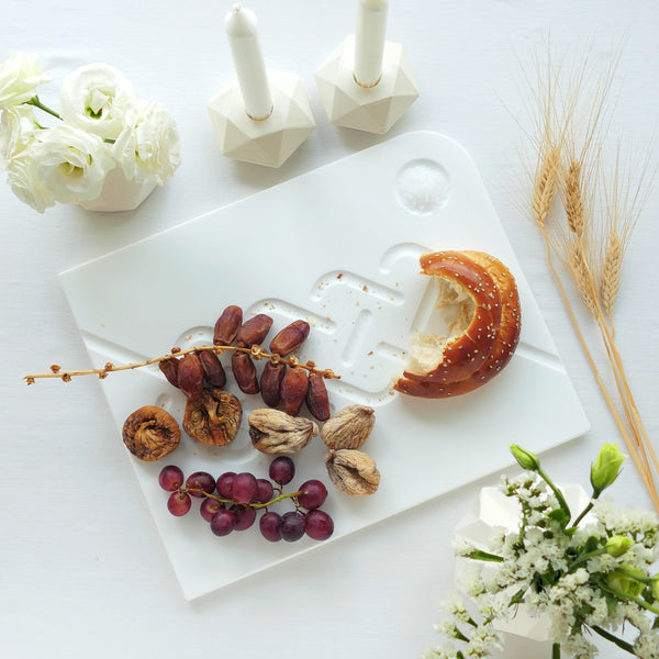 white corian challah tray with white minimalist shabbat candlesticks