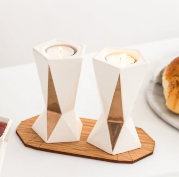 Pair of Shabbat candlesticks designed in geometric style. Off white ceramic with gold decoration